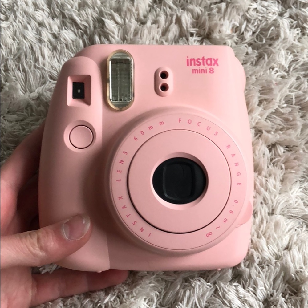 Pink instax mini 8 Polaroid camera with a case.